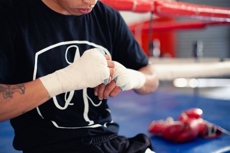 Boxer wrapping his hands before training