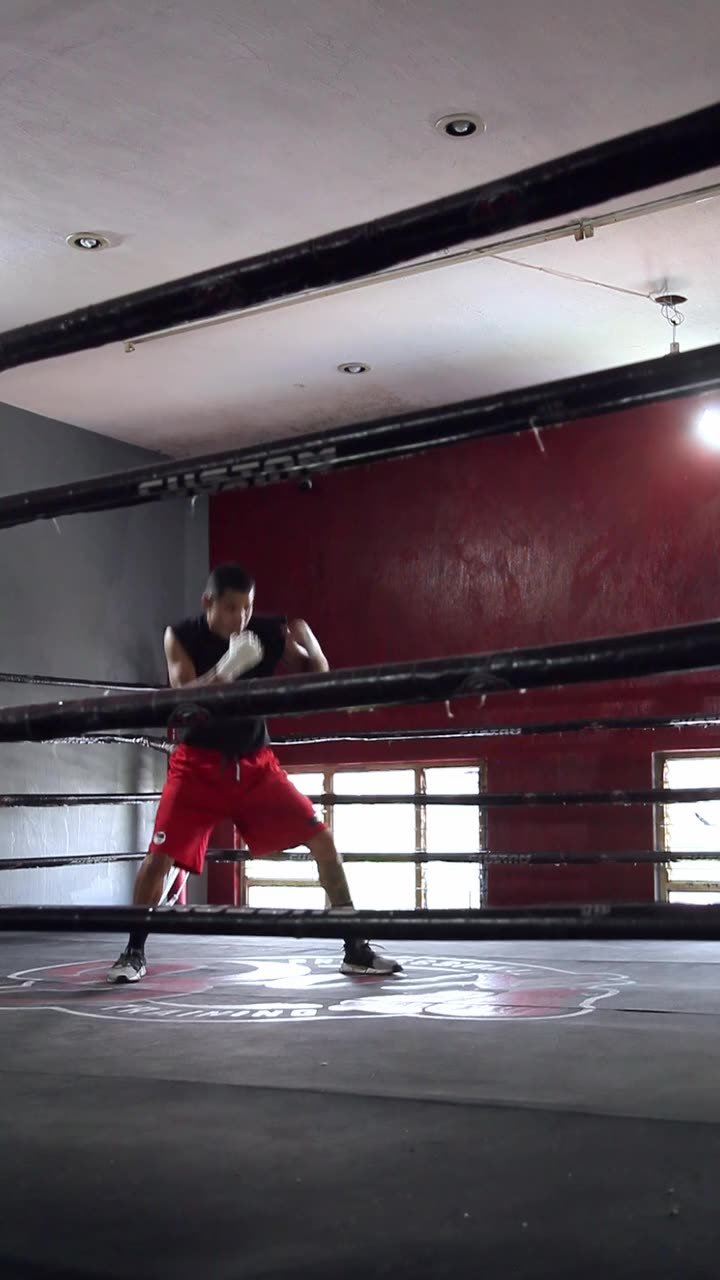 Boxer shadowboxing in the ring